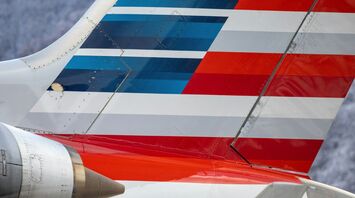 The tail section of an American Airlines airplane with red, white, and blue stripes