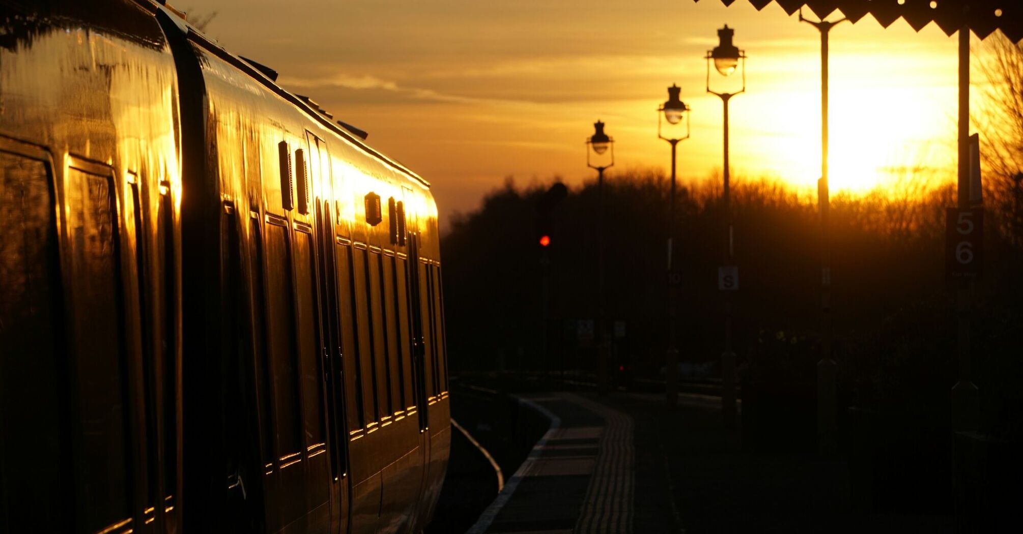 Train at a railway station during sunset 