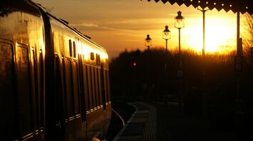 Train at a railway station during sunset