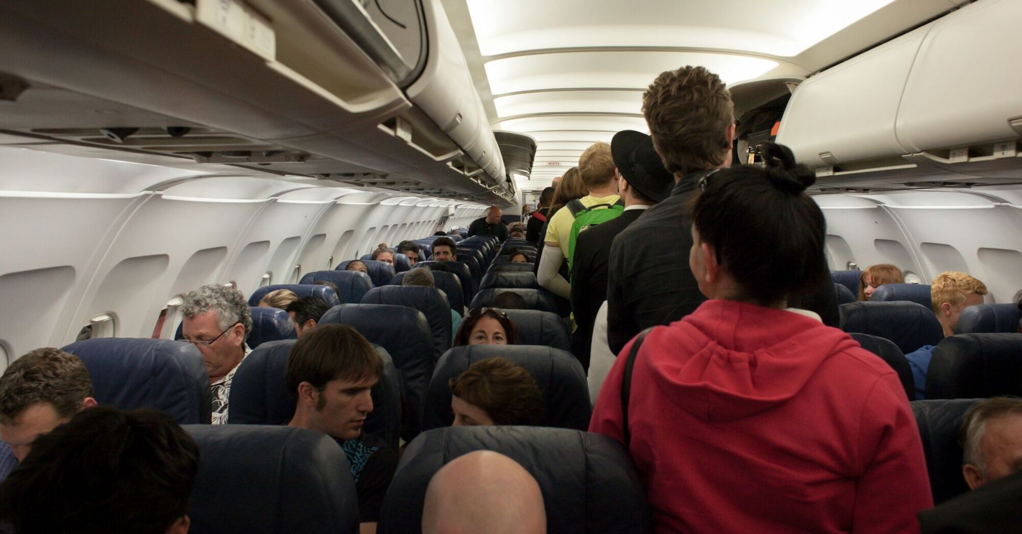 Passengers standing in aisle waiting to deplane 