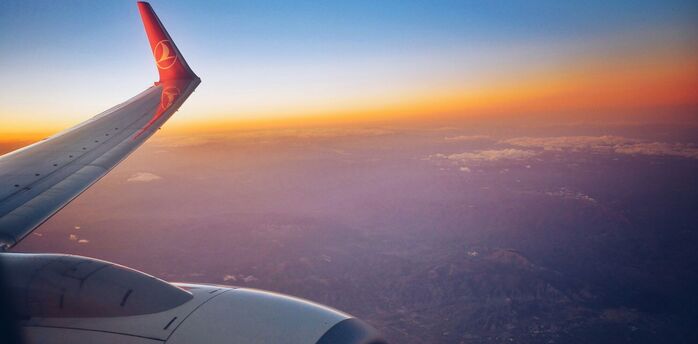 Photograph white and red airplane wing