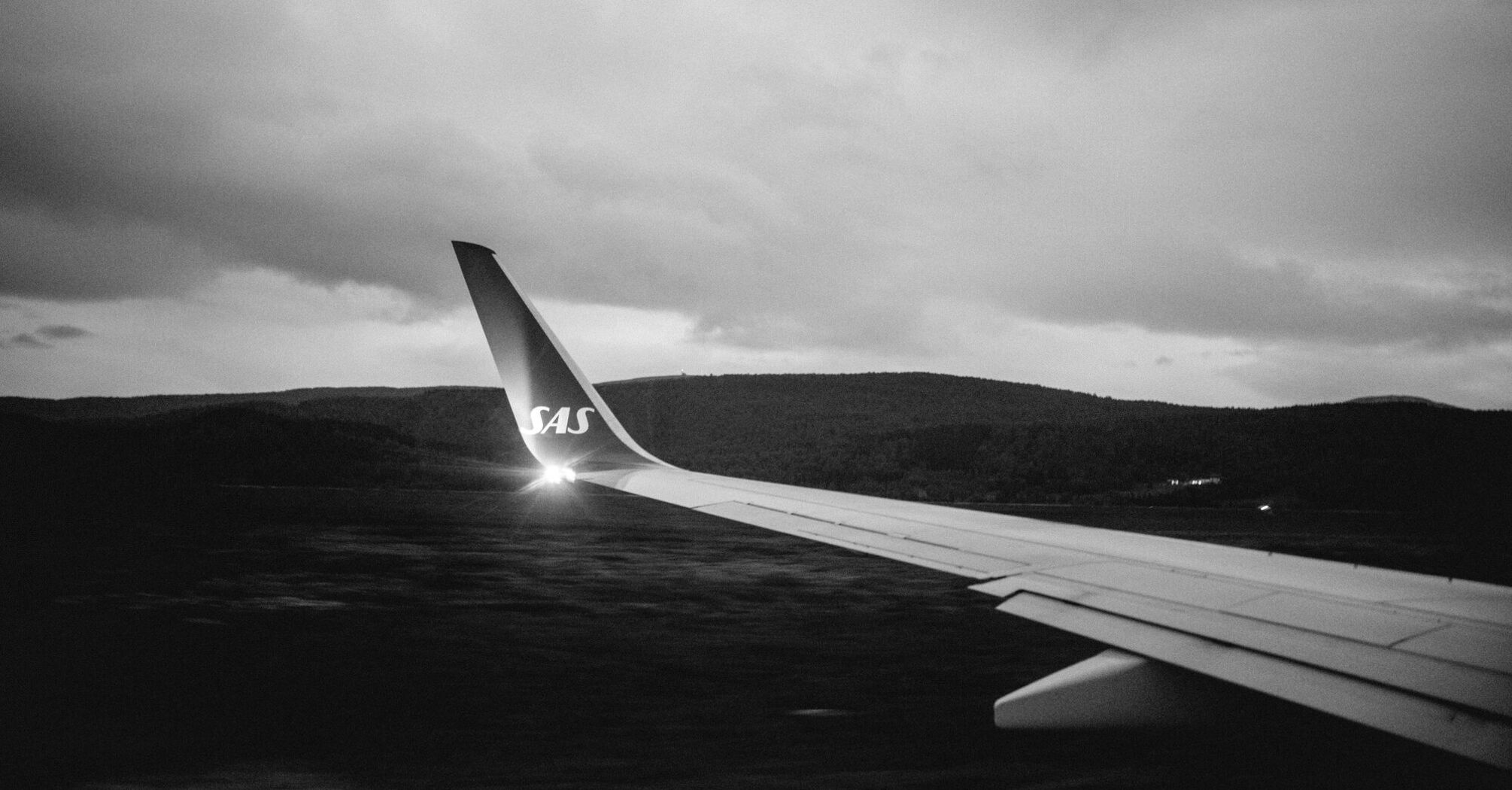 Grayscale photo of airplane wing
