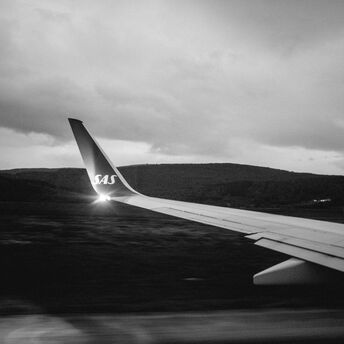 Grayscale photo of airplane wing
