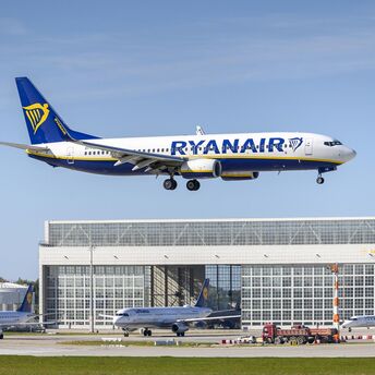 Ryanair airplane taking off with clear blue skies in the background