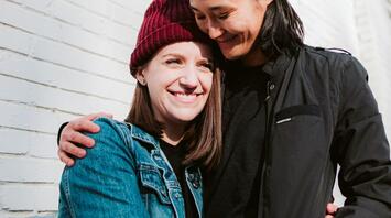 Two girls smiling and hugging