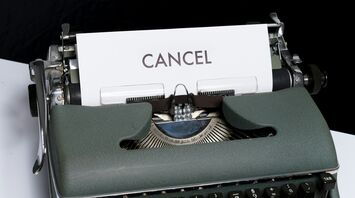 Vintage typewriter with a paper sheet reading 'CANCEL'