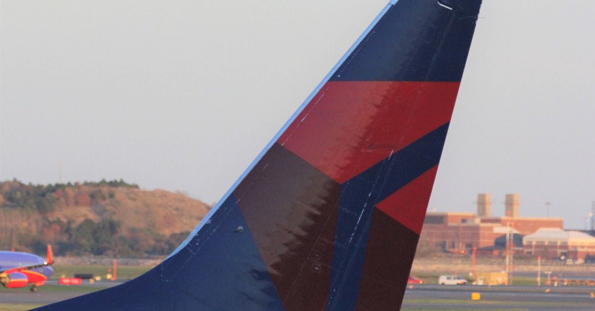 Delta Airlines tail fin on tarmac at dusk