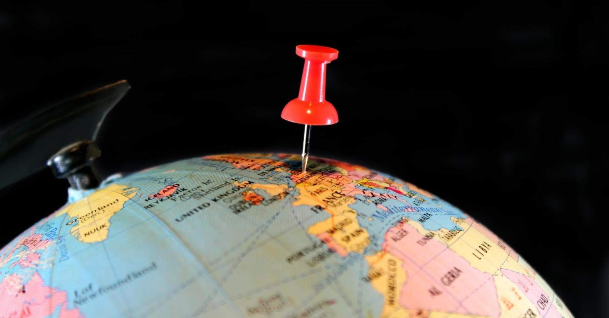 Travel destination indicated by a button on the globe