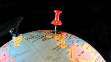 Travel destination indicated by a button on the globe