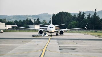 A large passenger jet sitting on top of an airport tarmac