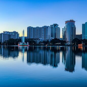 Orlando skyline reflected in tranquil lake at twilight
