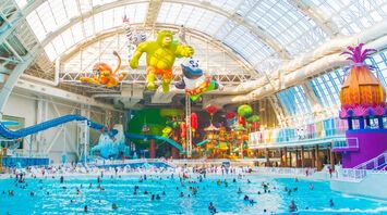 The best indoor water parks in the US for year-round summer vacations. Places to ride big water slides and waves