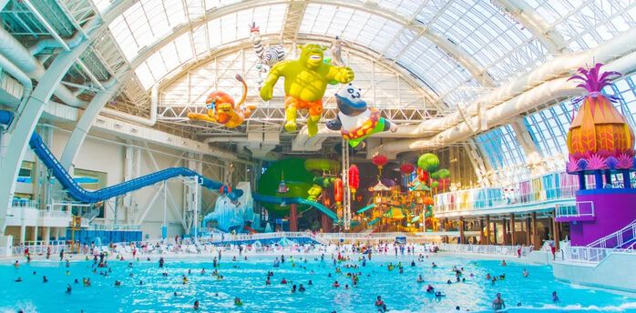 The best indoor water parks in the US for year-round summer vacations. Places to ride big water slides and waves