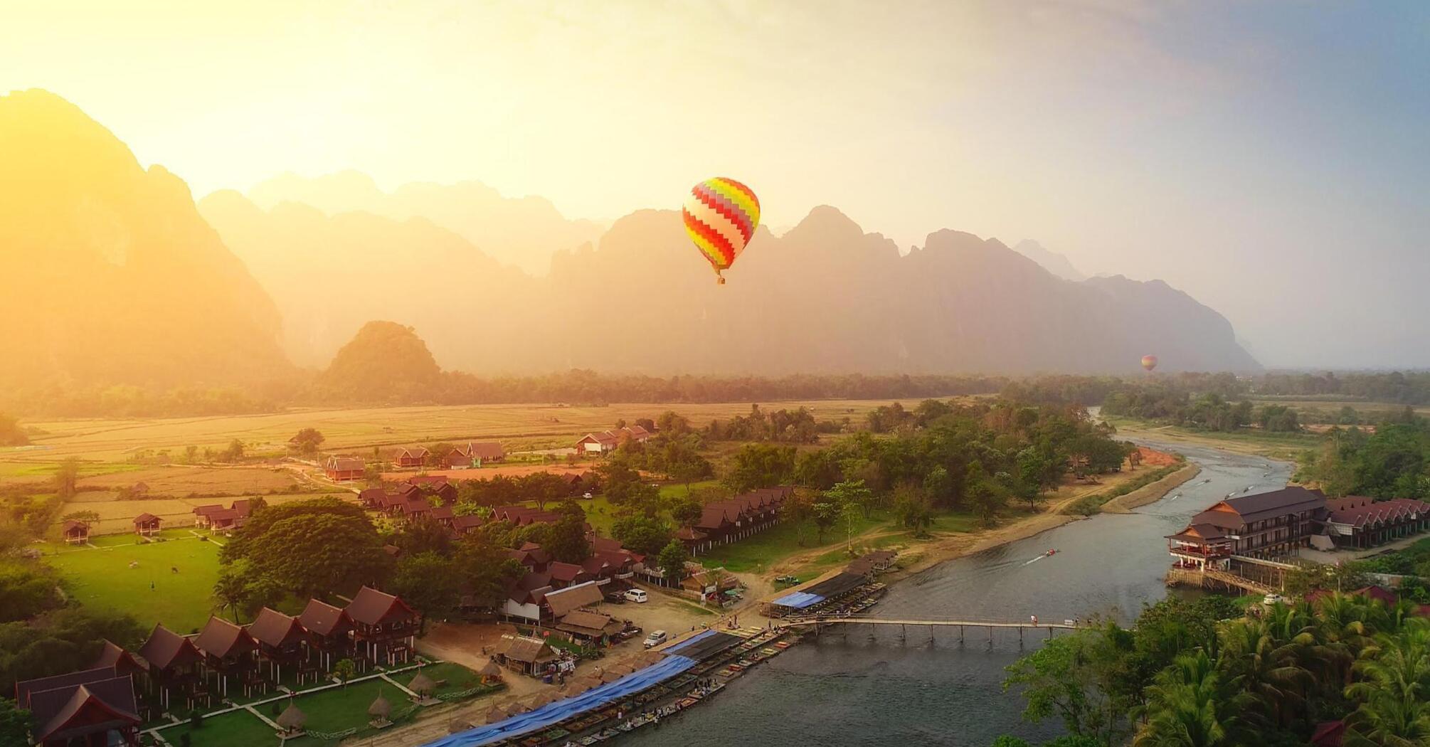 Air balloon over river and houses