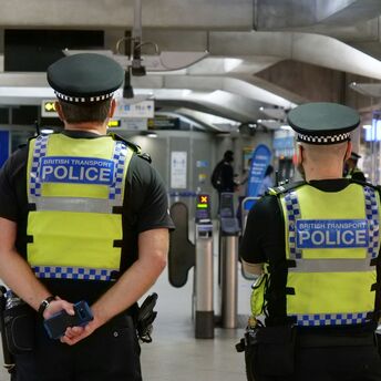 Two British Transport Police officers monitor security