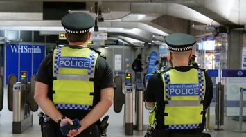 Two British Transport Police officers monitor security