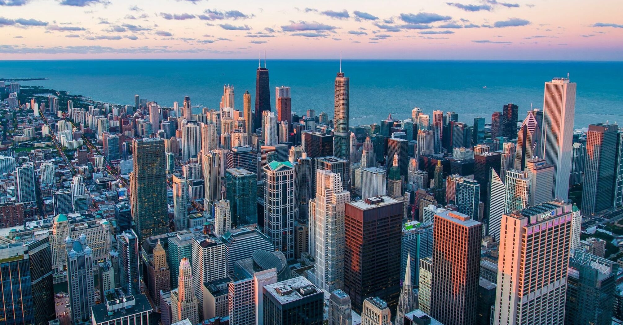 Aerial view of Chicago skyline at dusk with Lake Michigan