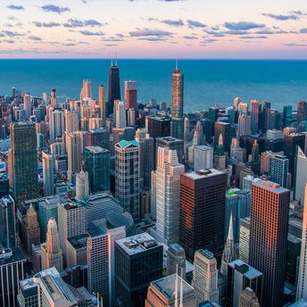 Aerial view of Chicago skyline at dusk with Lake Michigan