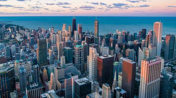 Aerial view of Chicago skyline at dusk with Lake Michigan