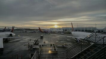 Sunrise view over JFK International Airport with various aircraft at the gates