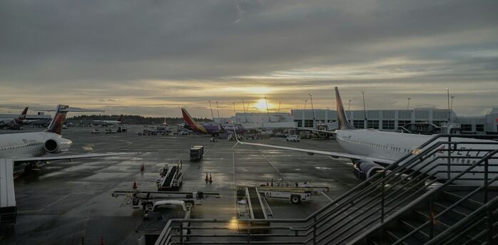 Sunrise view over JFK International Airport with various aircraft at the gates