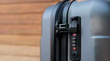 Close-up of a combination lock on a grey suitcase