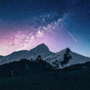 Snow-covered mountains under a starry sky with a meteor and a pink galactic nebula