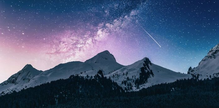 Snow-covered mountains under a starry sky with a meteor and a pink galactic nebula