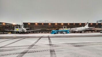 View of Helsinki Airport with Finnair planes and a service bus on a tarmac