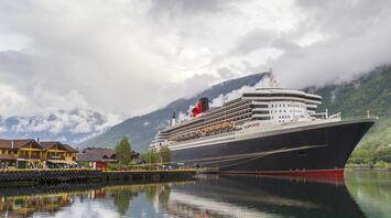 Large liner near mountains and houses