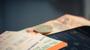 Tickets with coin on blue table