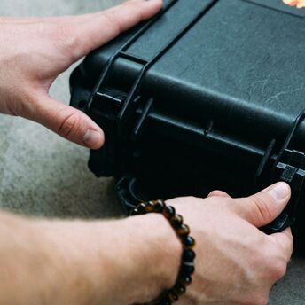 Person unlocking sturdy briefcase