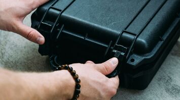 Person unlocking sturdy briefcase