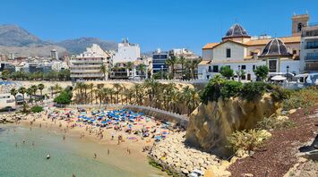 A beach with people and buildings