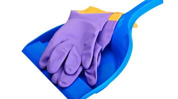 Purple rubber gloves and blue dustpan on a white background