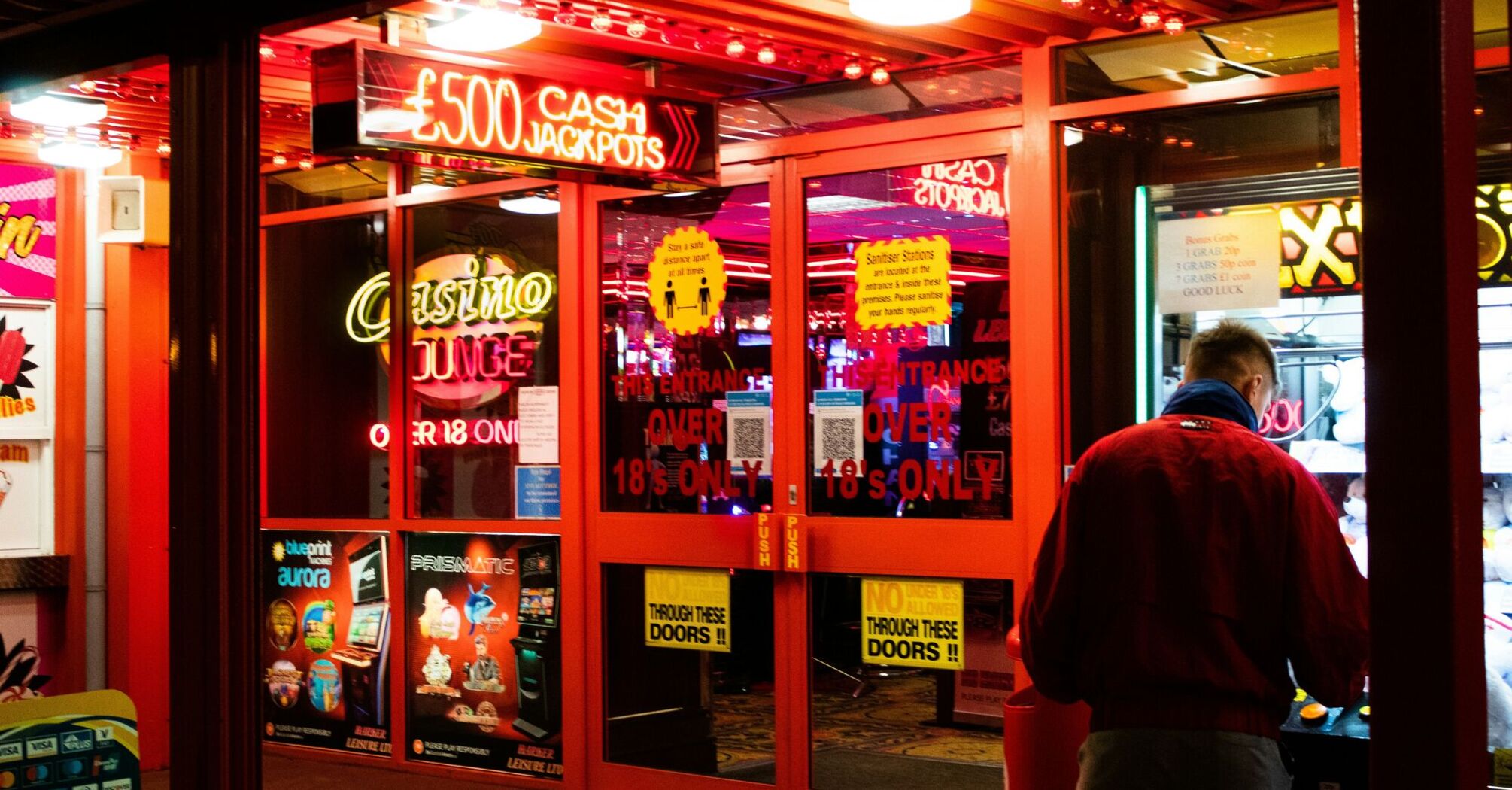 Man in red shirt standing near casino