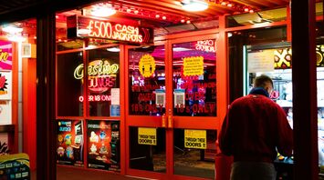 Man in red shirt standing near casino