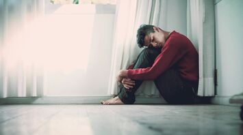 Man beside white frame window