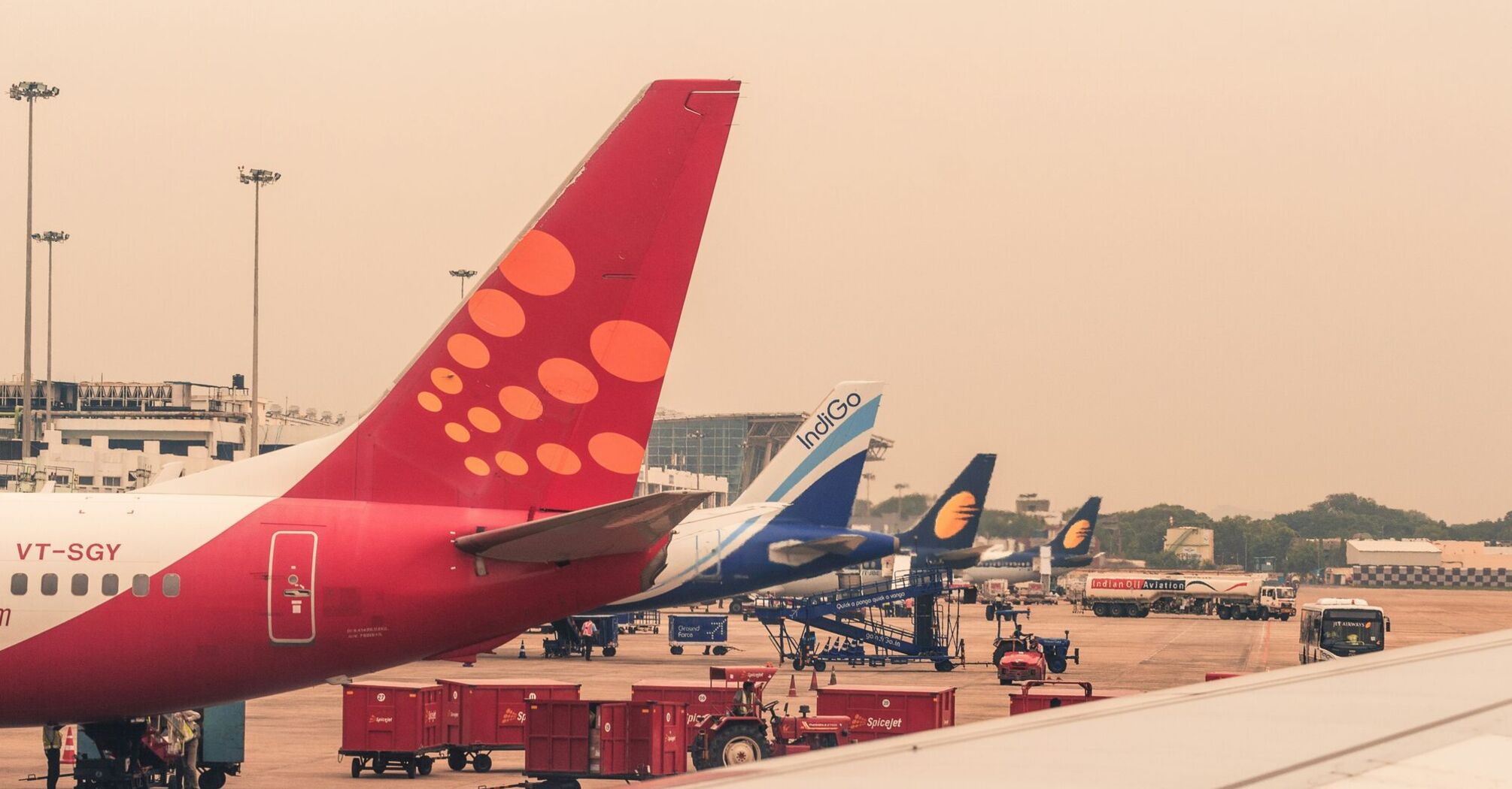Four airliners parked beside airport