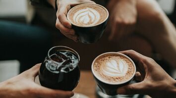 Three people engaging in a coffee tasting session