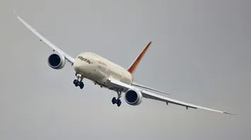 White and orange airplane in the air