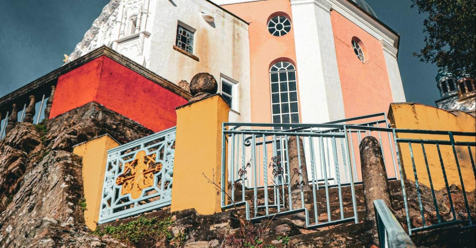 A colorful building with a steeple on top of it in Portmeirion