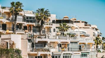 White concrete building with palm trees
