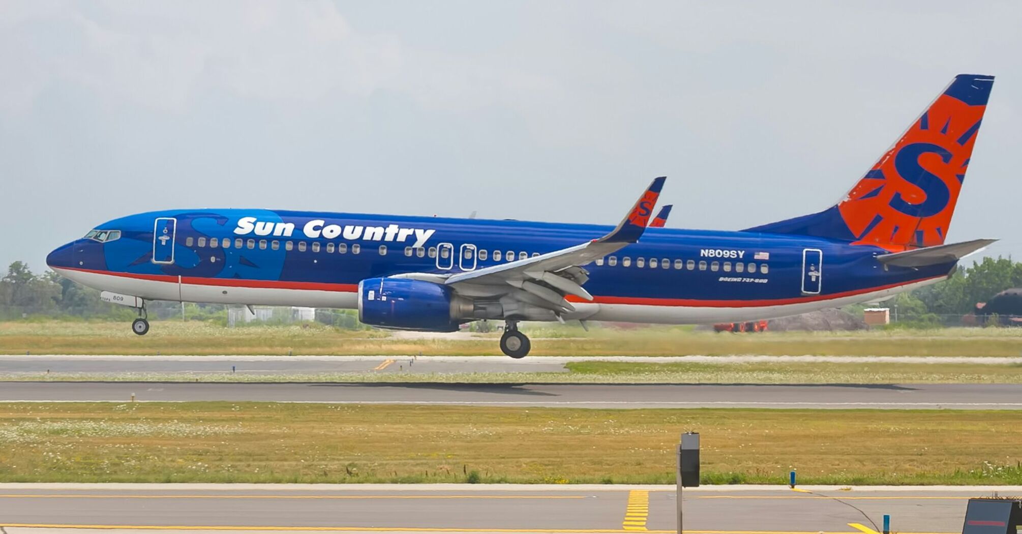 A Sun Country Airlines airplane landing on a runway
