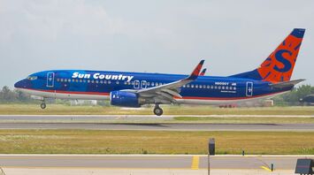 A Sun Country Airlines airplane landing on a runway