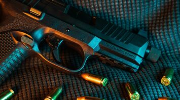 A close-up of a loaded handgun