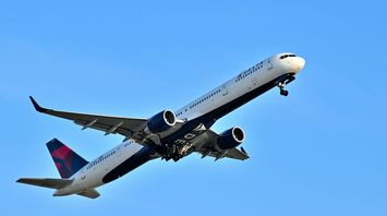 A large Boeing 757 airplane flying in the sky
