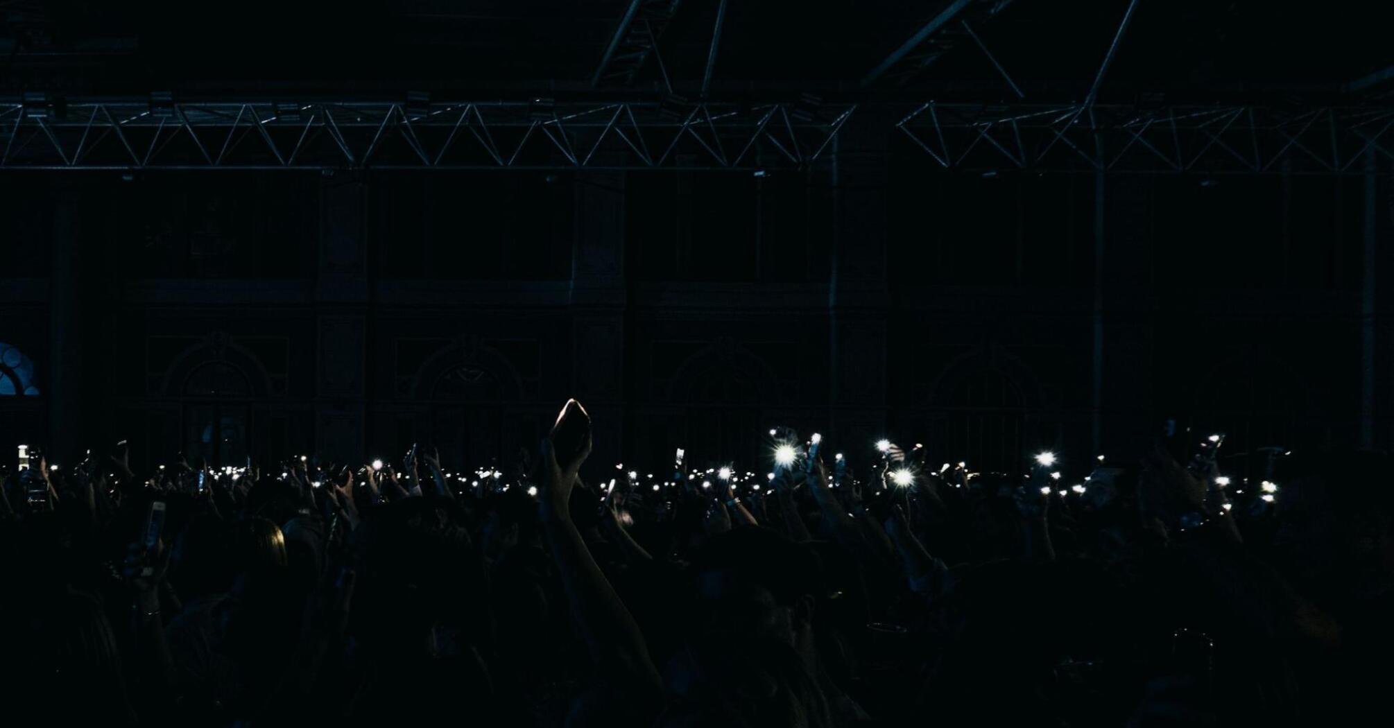 Crowd in the Alexandra Palace with flashlights