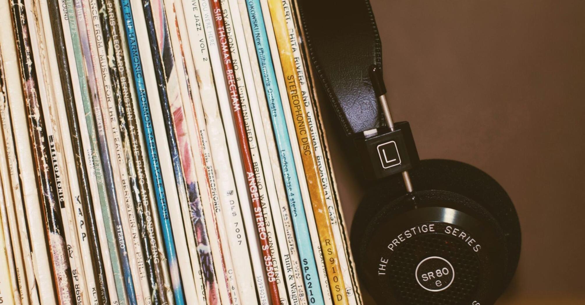 Headphones with music records stand on a shelf