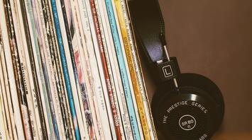Headphones with music records stand on a shelf